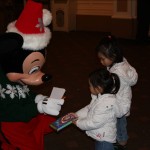Girls meet Holiday Mickey